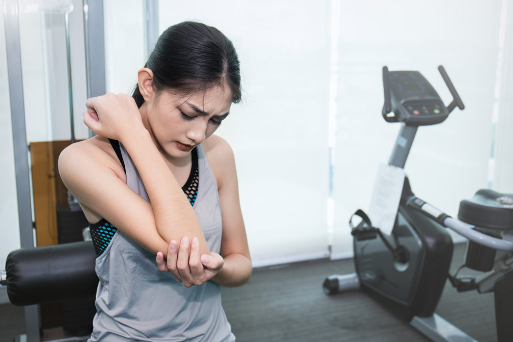 woman having a arm pain after her workout