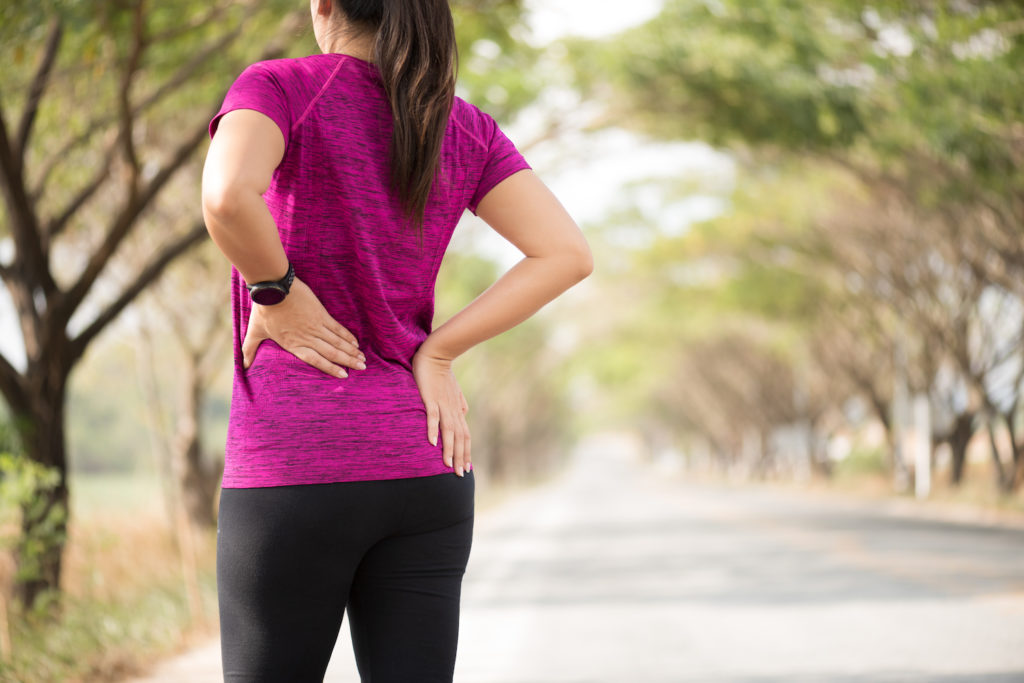 woman having a back pain after jogging