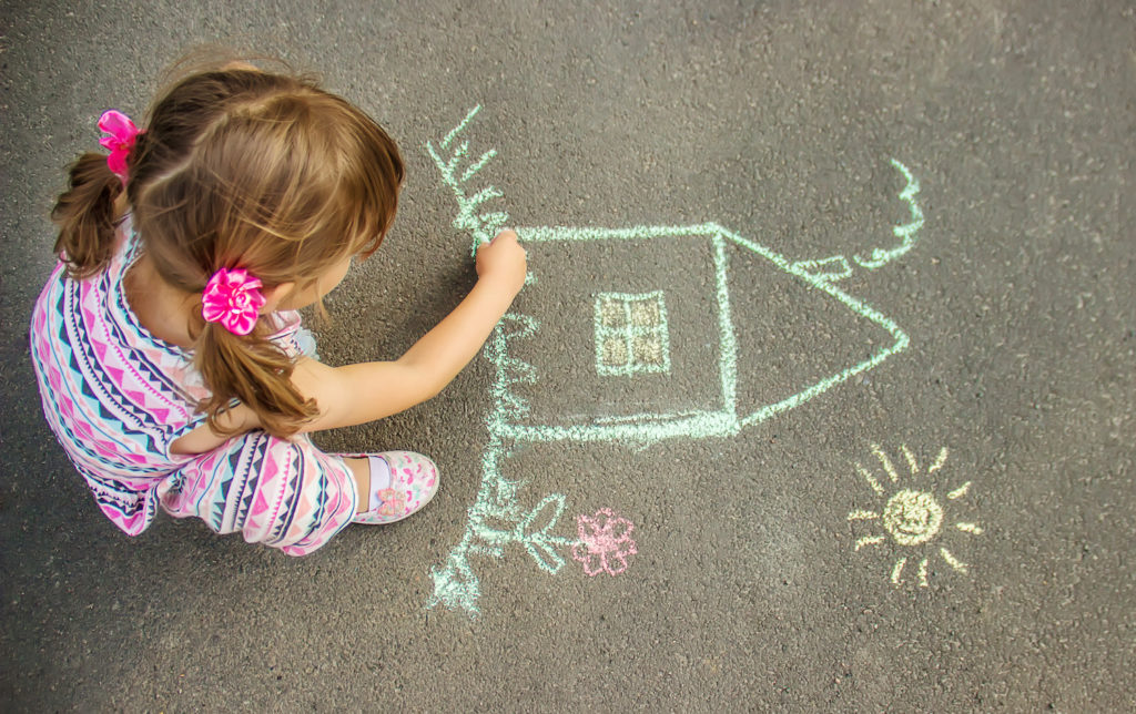 kid draw a house on the street