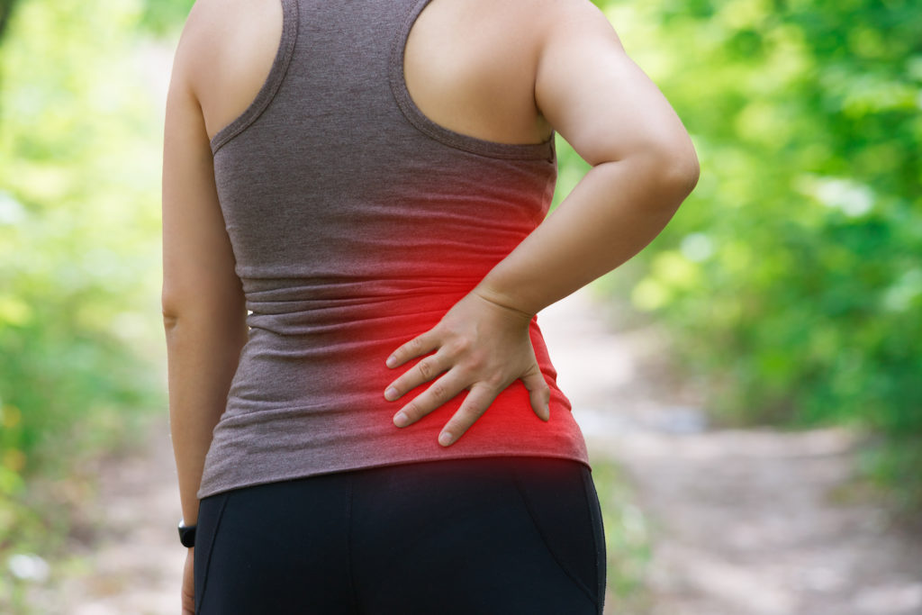 woman having a back pain after hiking cause from sciatica