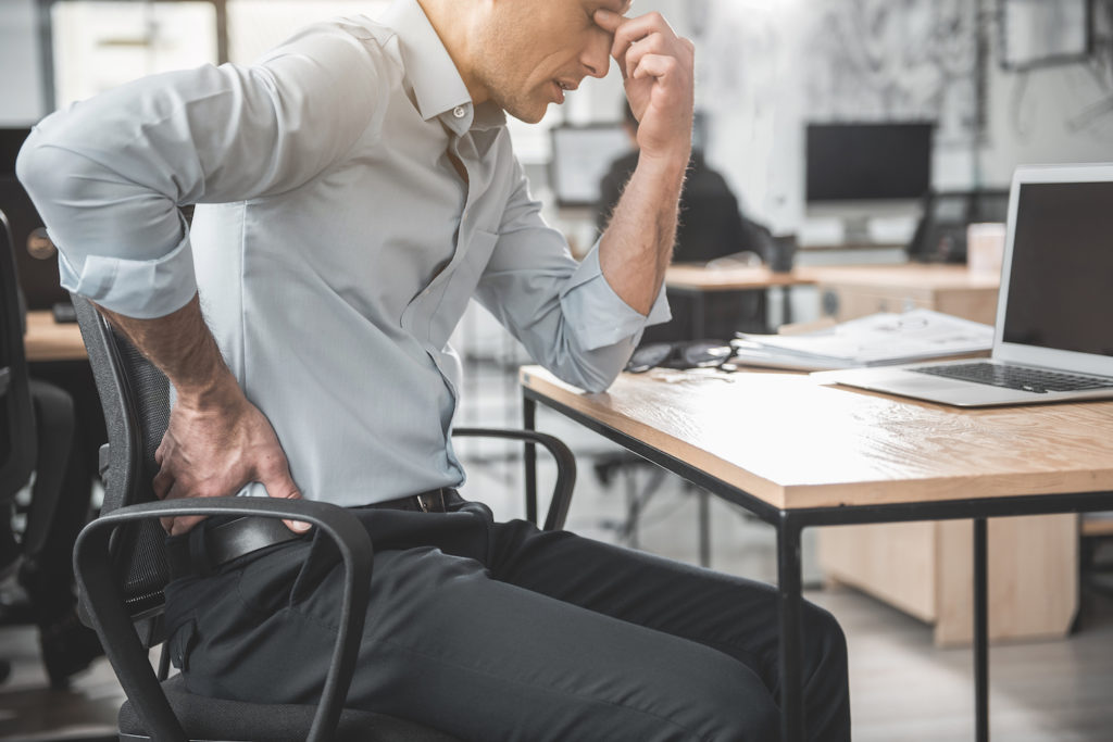man suffering from lower back pain after his work
