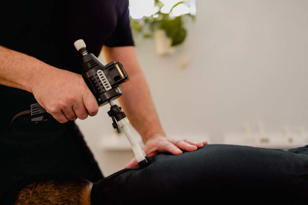 chiropractor giving his patient a Arthrostim Adjusting technique