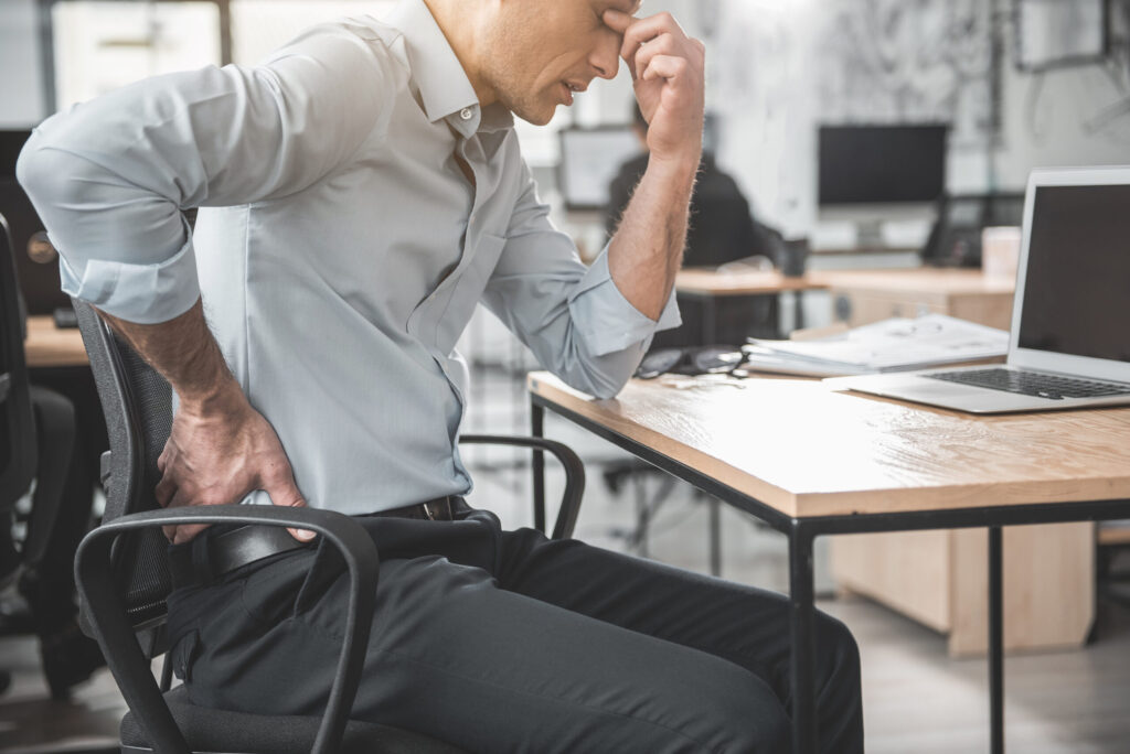 man having a lower back pain after his work