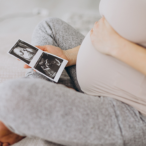 Home 6 pregnant woman holding a baby ultrasound result